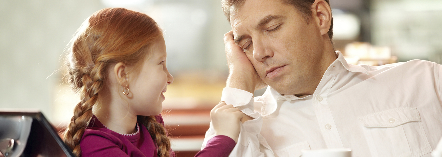 Daughter watches father sleep