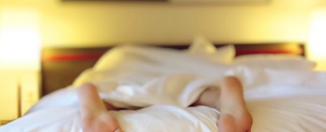 Person who can't sleep, with feet out from under comforter.