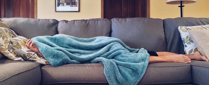 Man who has fallen asleep on the couch after eating.
