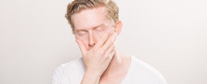 Man covering a yawn.
